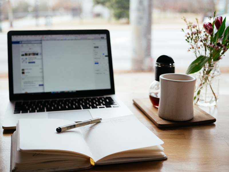 A notebook and laptop on a desk