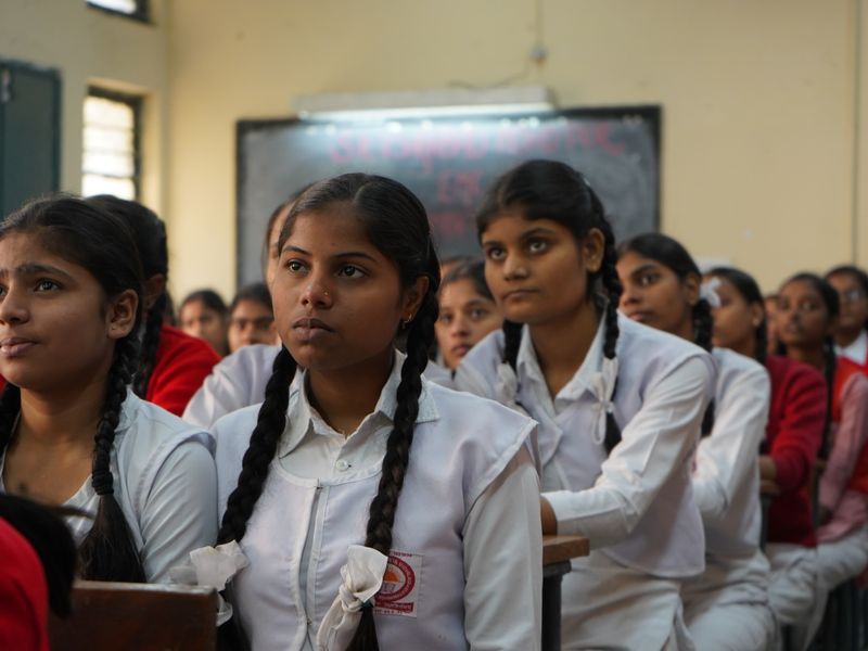 Indian school students in uniform listening in class